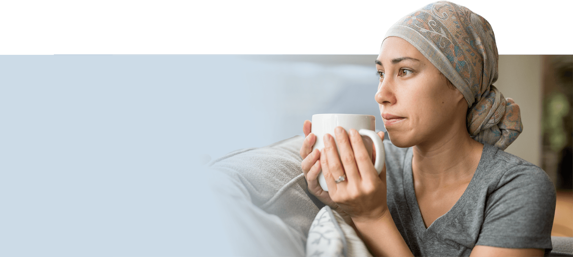 woman wearing a bandana and holding a mug