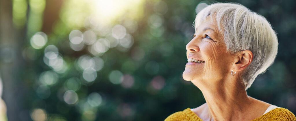 Woman smiling up while outside