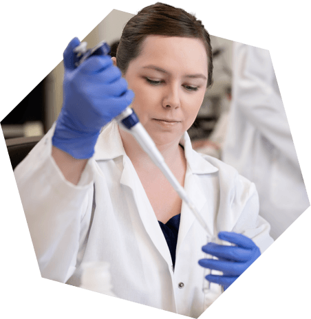 Researcher filling a test tube with liquid
