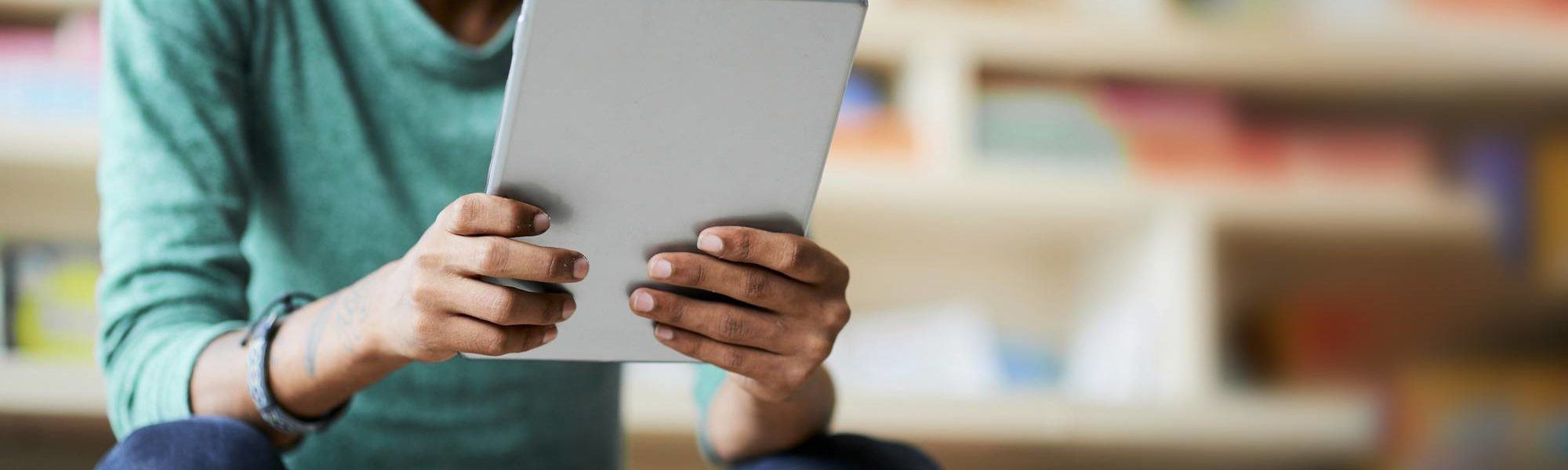 Man using a tablet to take online course