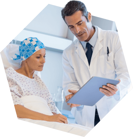Cancer patient looking at a clipboard with her doctor