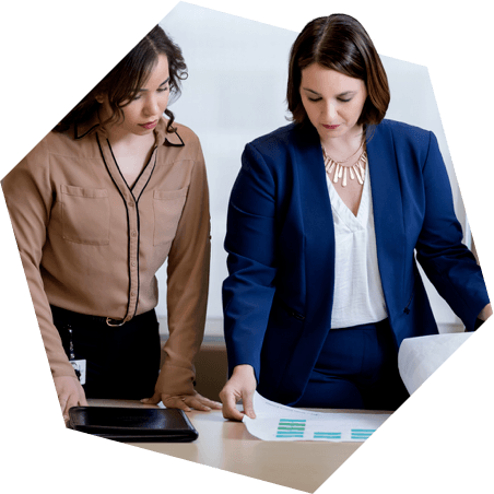 Two professionals reviewing paperwork