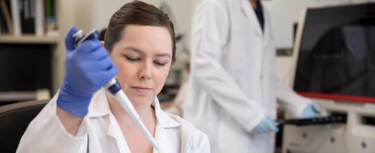 Researcher using pipette in lab