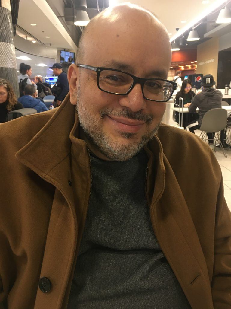Male brain tumor patient, Randy, sitting in crowded area