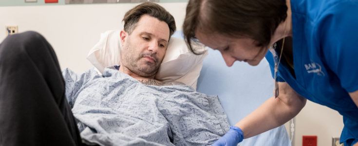 Nurse Kristin helping patient