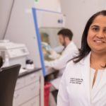 Dr. Mehta smiling in laboratory