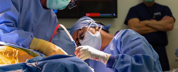 Neurosurgery resident performing brain surgery
