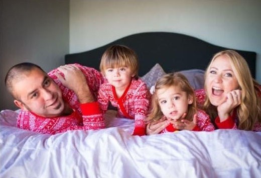Leon with his twin daughter and wife
