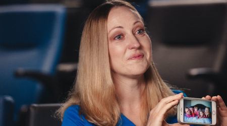 Terra Ybarra holding a photo of brother-in-law