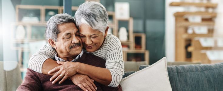 Elderly woman hugging her husband