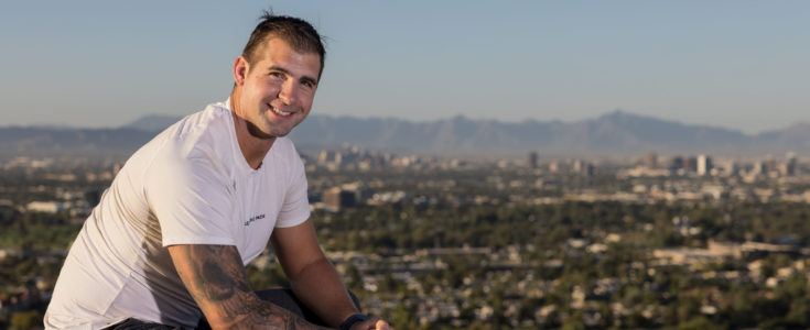 Ian Youngblood smiling on a mountain